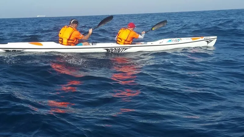 Point Apex 2, two paddlers on open water, side view